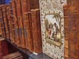 many old books on a shelf in a library