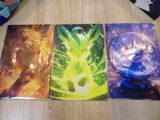 three pokemon cards sitting on top of a wooden table next to a pair of shoes