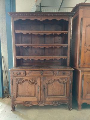 two wooden cabinets and a cupboard in a room