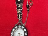 a black and white clock with a chain attached to it