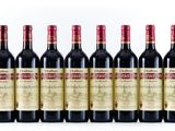 six bottles of red wine are lined up in a row