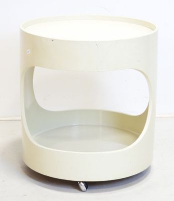 a small white table with wheels on the floor
