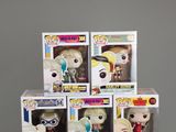 five pop vinyl figures in a display case on a table