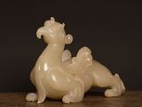 a small statue of a dragon sitting on a table