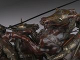statue of a man on a horse with a spear and a horse with a man on a horse