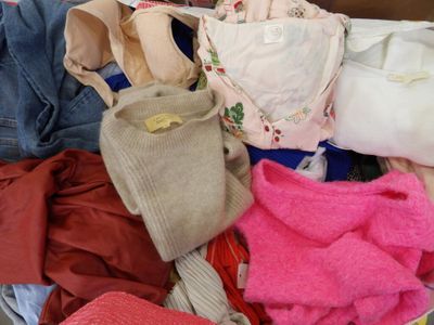 a pile of clothes that is sitting on the floor