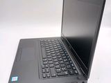 a laptop computer sitting on a table with a keyboard