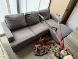 an image of a living room with a couch and a scooter