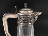 an antique silver plated glass pitcher with a handle and handle