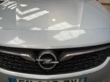 the front of a silver opel parked in a parking lot