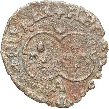 an old coin with a face on the side of it