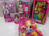 several barbie dolls are sitting on a table in front of a box