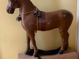 a wooden horse that is standing on a box