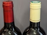 two bottles of wine that are sitting on a table