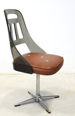 a chair that has a brown seat on a metal stand