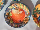 four plates with different designs on them on a table