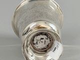 an image of a silver vase with a label on it