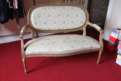 a couch that is sitting in a room with a red carpet