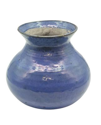 a blue vase that is sitting on a white surface
