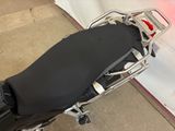 a black motorcycle with a black seat and a red handlebar