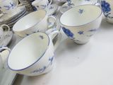 many cups and saucers on the table ready to be eaten