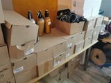 many boxes of items on a shelf in a room