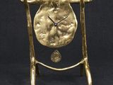 an image of a gold clock on a stand