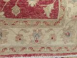 an image of a close up of a rug with a red and beige design