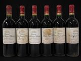 six bottles of wine lined up in a row on a black background