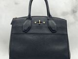 a black leather handbag on a white background