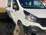 the white van is parked in a lot next to a building