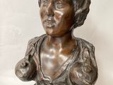 bronze bust of a woman on a pedestal with a plaque