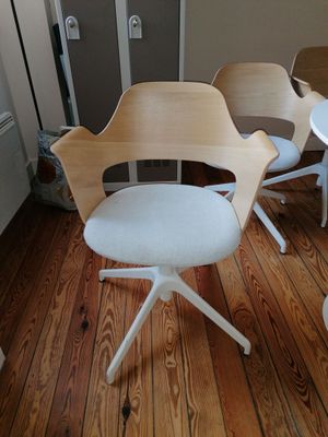 three chairs and a table in a small room