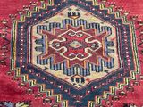 a close up of a red rug with a pattern on it