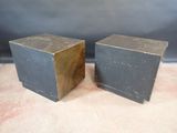 pair of black and brown wooden cubes on carpeted surface