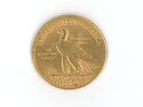 a gold coin with a bird on it on a white surface