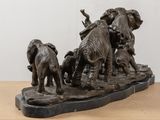 a statue of a group of elephants on a table