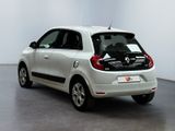 a small white car that is parked in a room