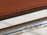 a close up of a brown leather chair with a name on it