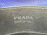 the inside of a prada bag with a blue background