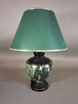 une lampe verte surmontée d'un abat-jour vert