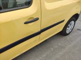 a small yellow van parked on the side of the road