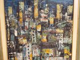 an oil painting of a cityscape in a gold frame