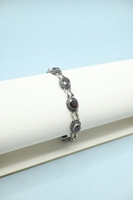 a close up of a bracelet on a napkin on a table