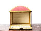 a small wooden box with a pink top on a table