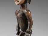 a wooden statue of a man with a helmet on his head