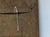 an old wooden box with a rope hanging on it