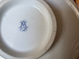 a white plate with a blue design on it sitting on a table