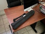 a desk with a laptop and a black umbrella on it