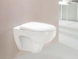 a white toilet sitting in a bathroom next to a mirror
